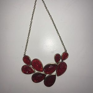 2 gold and red necklaces